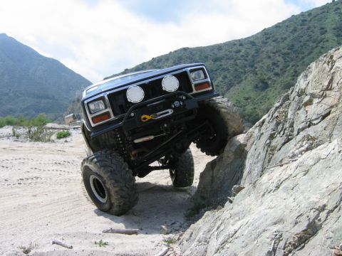1985 Ford Bronco - This 1985 Ford Bronco navigates a challenging rocky terrain, its off-road capabilities.