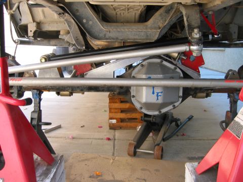 1997 Ford Ranger - Custom rear axle assembly with aftermarket suspension parts, supported by jack stands and a floor jack.