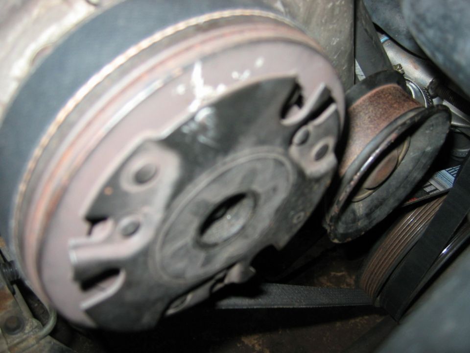 Close-up of a car's engine belt tensioner pulley and belt