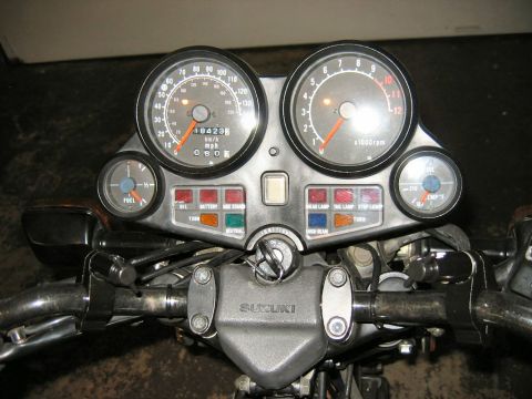 1985 Ford LTD Crown Victoria - A motorcycle's instrument cluster displays speed, RPM, fuel level, and various indicator lights.