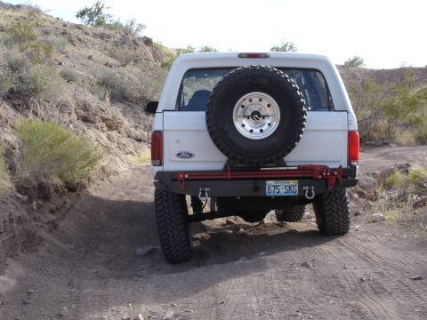 1996 Ford Bronco - 1996 Ford Bronco seen on a dirt road with aftermarket rear bumper and spare tire.