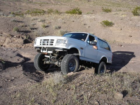 1996 Ford Bronco - A modified 1992 Ford Bronco navigates a rocky, desert terrain.