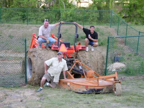 1995 Ford Bronco - Men pose with a tractor and mower, one man is on the tractor tire.