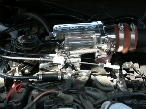2001 Mercury Grand Marquis - Close-up of a chrome Accufab throttle body and plenum installed on an engine.