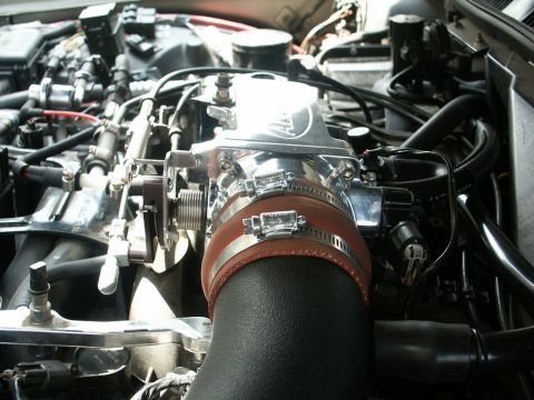 2001 Mercury Grand Marquis - Close-up of an engine bay, focusing on a chrome Accufab throttle body and a black intake tube.