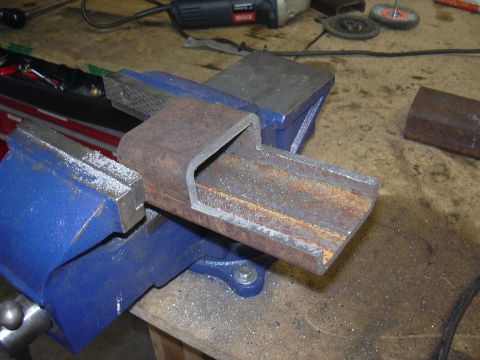 1991 Ford Bronco - A metal component is secured in a vise, ready for modification or repair.