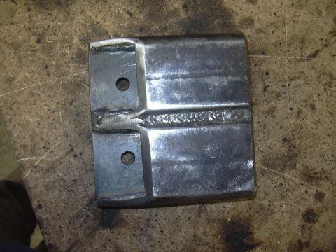 1991 Ford Bronco - A close-up view of a welded metal bracket two pre-drilled holes.