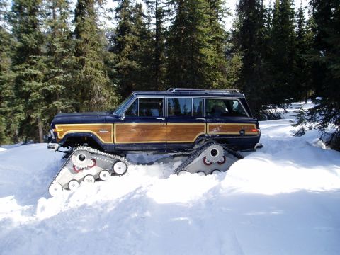 2000 Ford E350 - This classic Jeep Grand Wagoneer is equipped with snow tracks for off-road winter travel.
