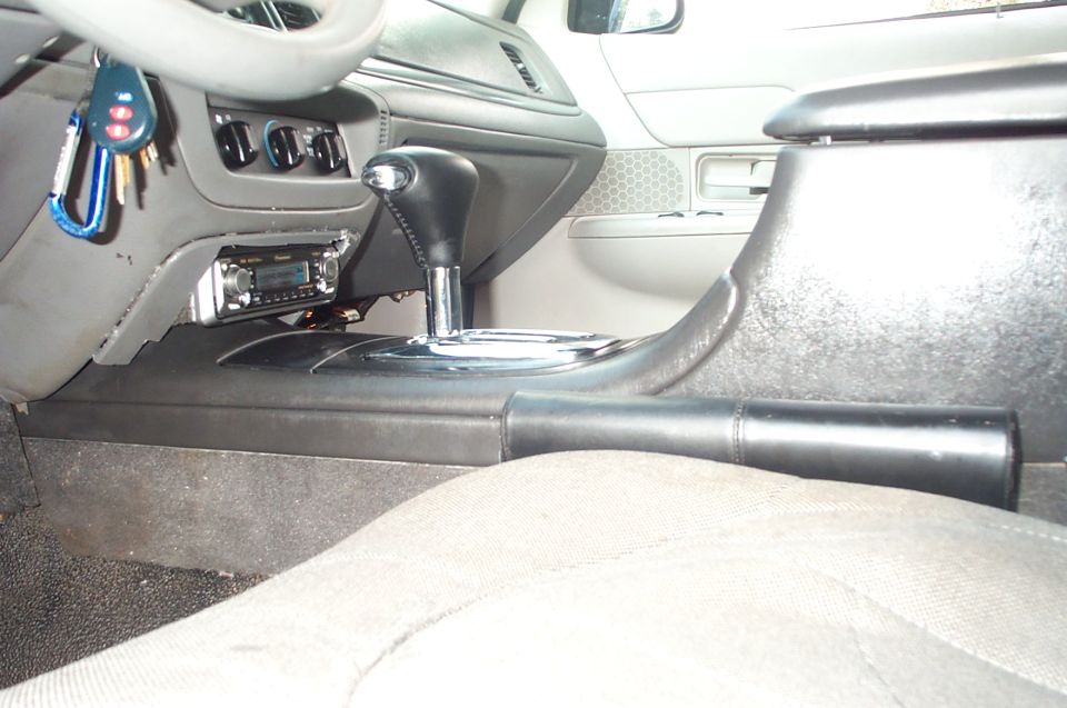 Gray console interior with floor automatic shifter, radio head unit and keys in column