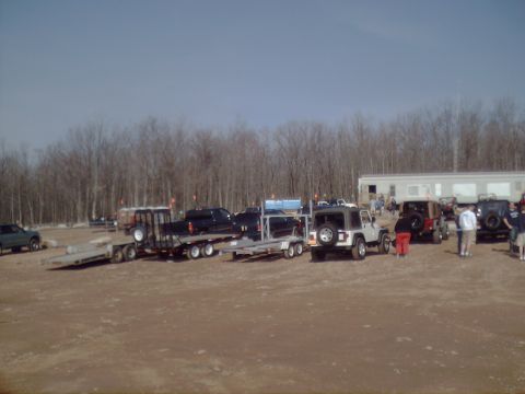 1991 Ford Bronco - Multiple vehicles, trailers, and a building are visible in this outdoor scene.