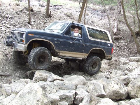 1986 Ford Bronco - 1986 Ford Bronco tackling a challenging rock garden terrain.