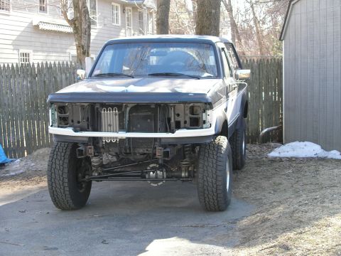 1994 Ford Bronco - Front view of a 1992 Ford F-150 truck undergoing repairs or modifications.
