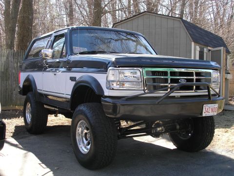 1994 Ford Bronco - This lifted Ford Bronco features a two-tone paint scheme and a custom front bumper with a brush guard.