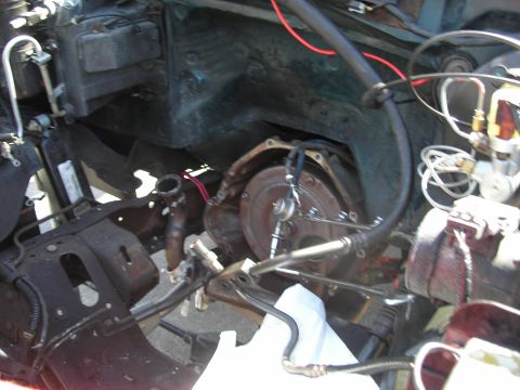 1994 Ford Bronco - Close-up view of a vehicle's engine bay, focusing on the transmission and exhaust components.
