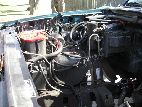 1994 Ford Bronco - Engine bay components including dual batteries, hoses, and wiring are visible in this photo.