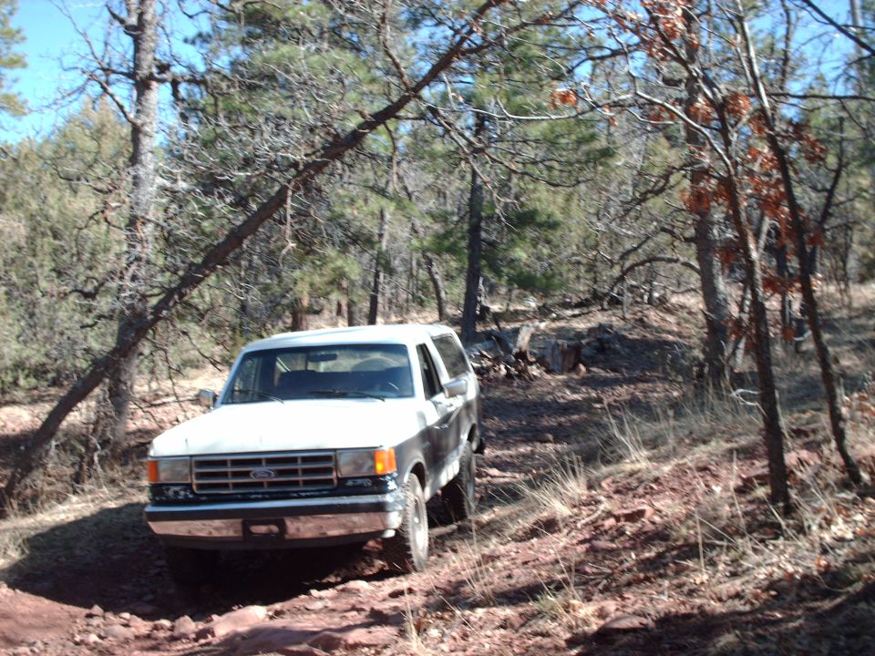 1987 Ford Bronco 3q-front view on wooded dirt trail