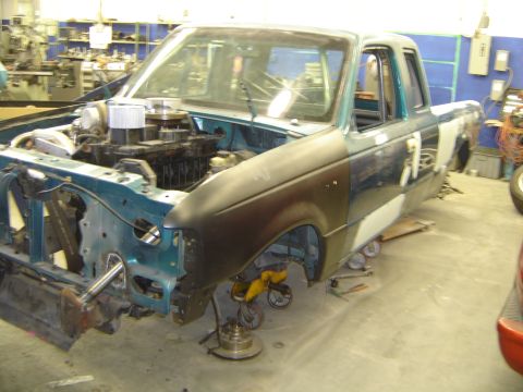 1997 Ford Ranger - A 1997 Ford Ranger truck is shown in a workshop with its engine compartment open and parts removed.