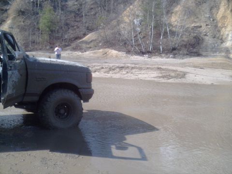 1991 Ford Bronco - This vehicle appears to be stuck in a muddy puddle during an off-road excursion.