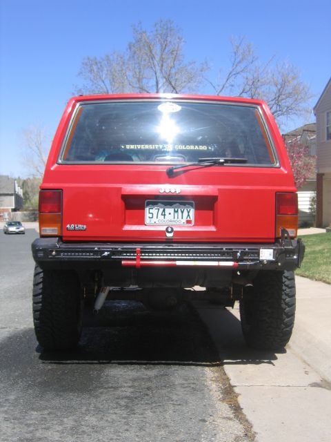 1996 Jeep Cherokee - Rear view of a 1996 Jeep Cherokee showing its bumper and a mounted jack.