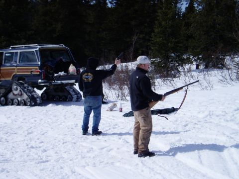 2000 Ford E350 - A wood-paneled SUV equipped with tracks instead of wheels is parked in a snowy landscape with two people nearby.