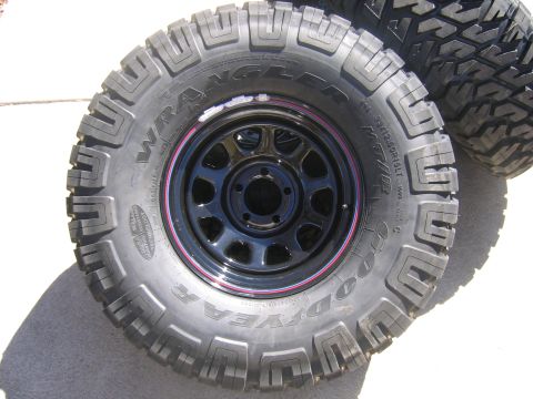 1996 Jeep Cherokee - Close-up of a Goodyear Wrangler MT/R tire and rim, with another tire visible in the background.