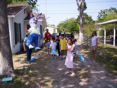 1986 Ford Bronco - A group of children and adults watch as a girl prepares to hit a bunny piñata.