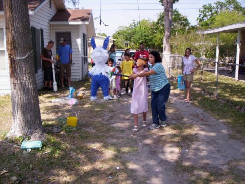 1986 Ford Bronco - A group of people are gathered for a piñata game in a yard.
