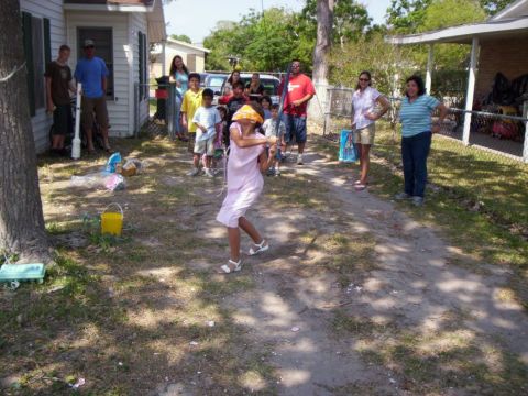 1986 Ford Bronco - A group of people, including children and adults, are gathered for an outdoor piñata game.