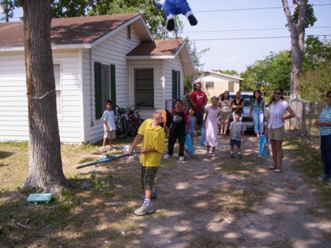 1986 Ford Bronco - A group of people are gathered for an outdoor party, with a piñata hanging overhead.