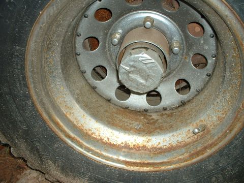1985 Ford Bronco - The wheel hub and tire show significant rust and wear.