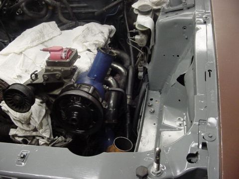 1995 Ford Mustang - Close-up view of engine components, including a turbocharger, with some parts covered by white cloths.
