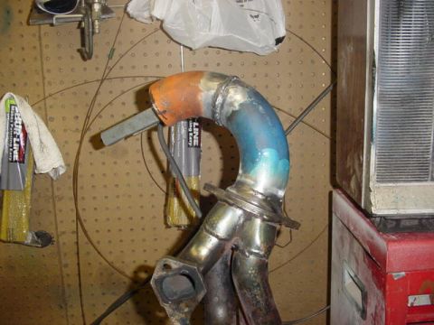 1995 Ford Mustang - Custom exhaust manifold shows signs of heat treatment in orange and blue.