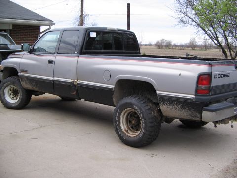 1997 Dodge 2500 - This 1997 Dodge 2500 pickup truck is shown from its side, a two-tone paint scheme and lifted suspension.