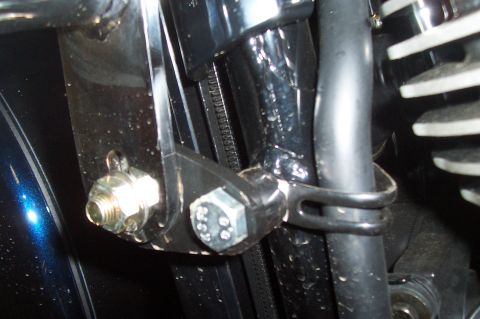 1994 Ford F-150 - Detail shot of a motorcycle engine component, a bolt and a hose clamp.