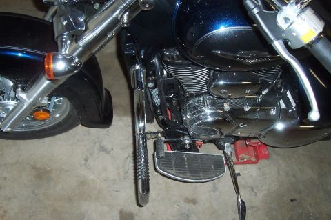 1994 Ford F-150 - A close-up view of a motorcycle's engine and front wheel assembly, showing chrome details and a dark blue fuel tank.