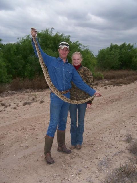 1986 Ford Bronco - A couple proudly displays a large rattlesnake they encountered outdoors.