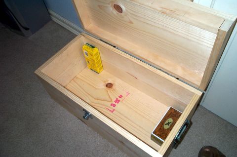 1996 Ford Bronco - Wooden chest with a yellow box and cards inside.