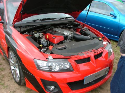 2001 Ford Fiesta - Red car's engine bay exposed, with a blue car parked nearby. "Maloo" is visible on the front.