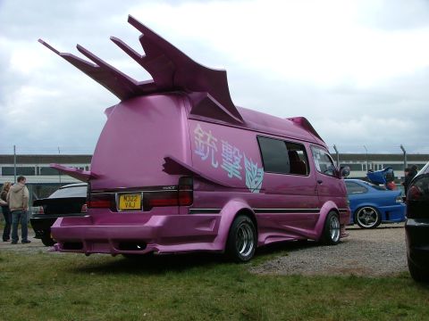 2001 Ford Fiesta - This customized van features unique fin-like spoilers and Japanese characters on its side.