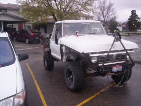 1978 Ford Bronco - Modified 1978 Ford Bronco pickup truck with custom front-end modifications and large tires.