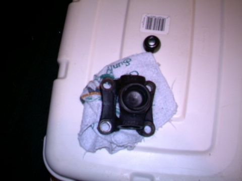 1987 Ford Bronco II - A driveshaft part is shown on a towel next to a cap and a barcode sticker.