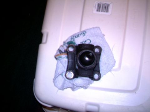 1987 Ford Bronco II - A driveshaft center support bearing rests on a cloth atop a white surface.