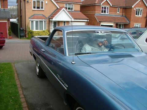 1970 Ford Ranchero - A blue 1970 Ford Ranchero is parked in a driveway with houses in the background.