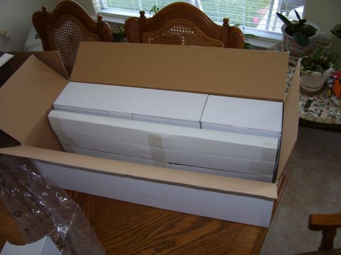1992 Ford Bronco - A large cardboard box is open, revealing multiple white packaged items stacked inside.