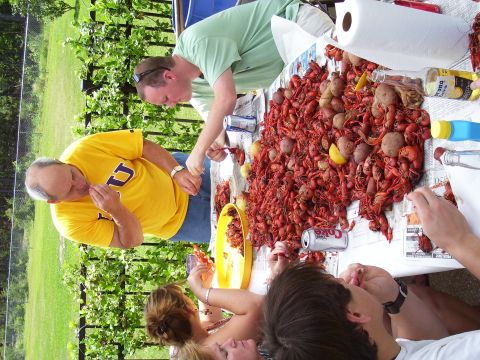 1992 Ford Bronco - A group enjoys a crawfish boil outdoors, with a table full of food and beverages.