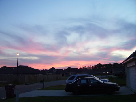 1992 Ford Bronco - Two cars are parked in a driveway with a colorful sunset in the background.
