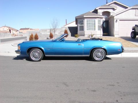 1973 Mercury Cougar - Blue 1973 Mercury Cougar convertible parked on a street in front of a house.