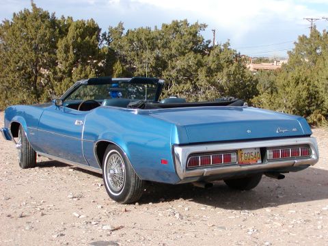 1973 Mercury Cougar - Blue 1973 Mercury Cougar convertible parked on a dirt road with trees in the background.