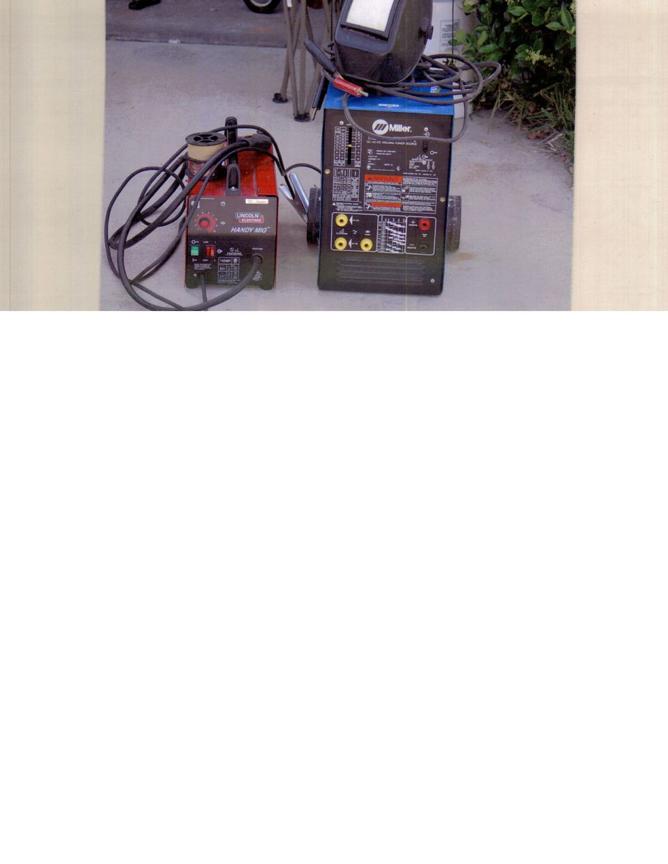 Lincoln Electric Handy MIG and blue Miller welder on concrete with welding helmet