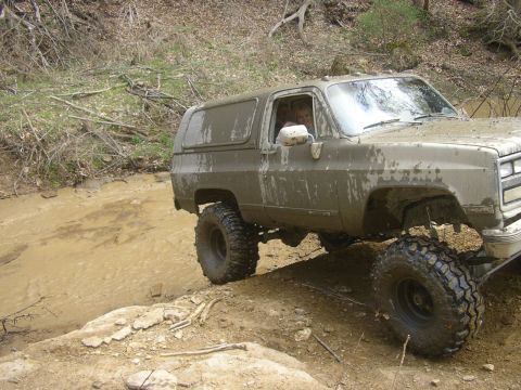1989 GMC Jimmy - This SUV is navigating a challenging muddy off-road course.